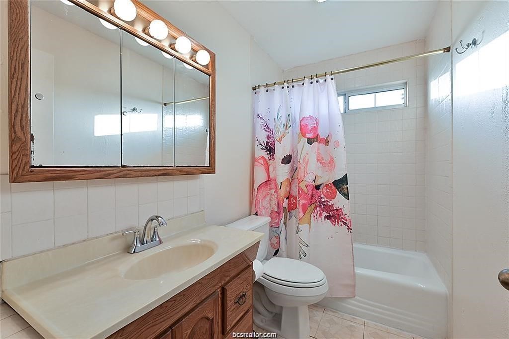 9776 Calhoun Road Bryan, TX 77808 - Photo 31 of 50 a bathroom with a sink toilet and shower