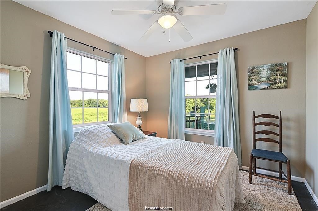 9776 Calhoun Road Bryan, TX 77808 - Photo 35 of 50 a bedroom with a bed and a window