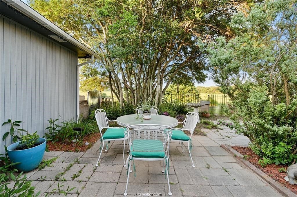 9776 Calhoun Road Bryan, TX 77808 - Photo 38 of 50 a view of a chair and table in backyard