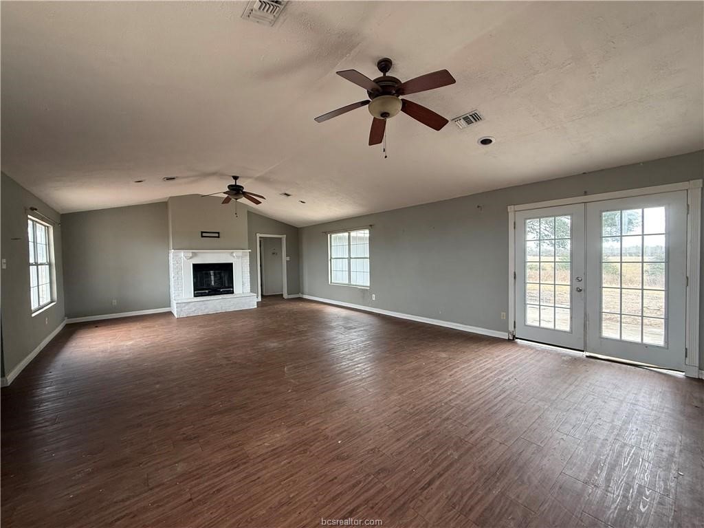 9776 Calhoun Road Bryan, TX 77808 - Photo 7 of 50 a view of empty room with wooden floor and fan