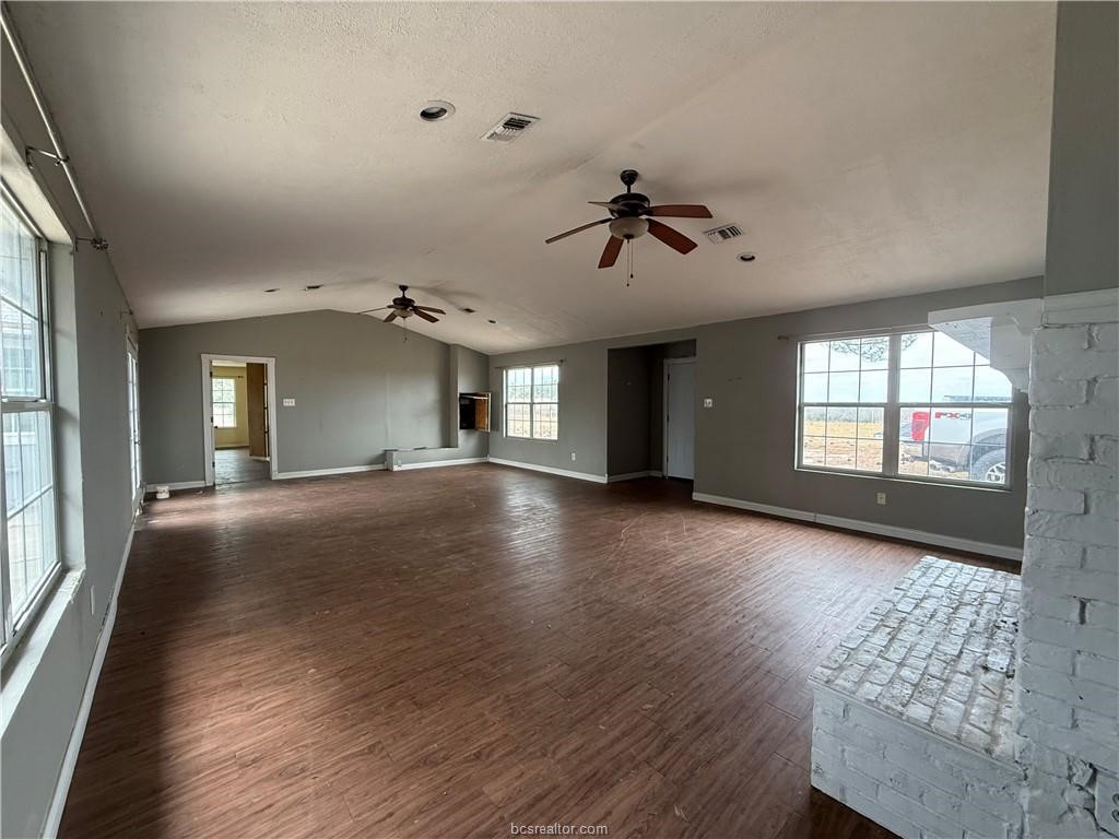 9776 Calhoun Road Bryan, TX 77808 - Photo 8 of 50 a view of empty room with wooden floor and fan