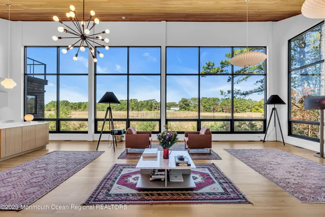 a living room with fireplace furniture and a floor to ceiling window