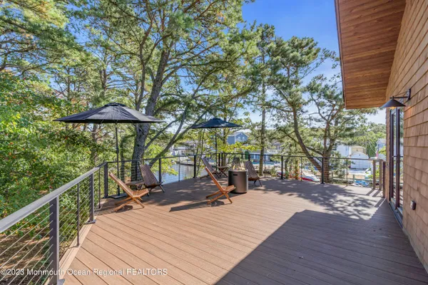 a patio with hardwood table and chairs