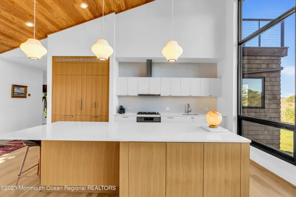a kitchen with a sink and a view of living room