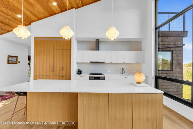 a kitchen with a sink and a view of living room