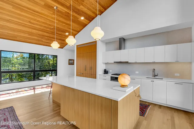 a kitchen with stainless steel appliances kitchen island granite countertop a stove a sink and a microwave