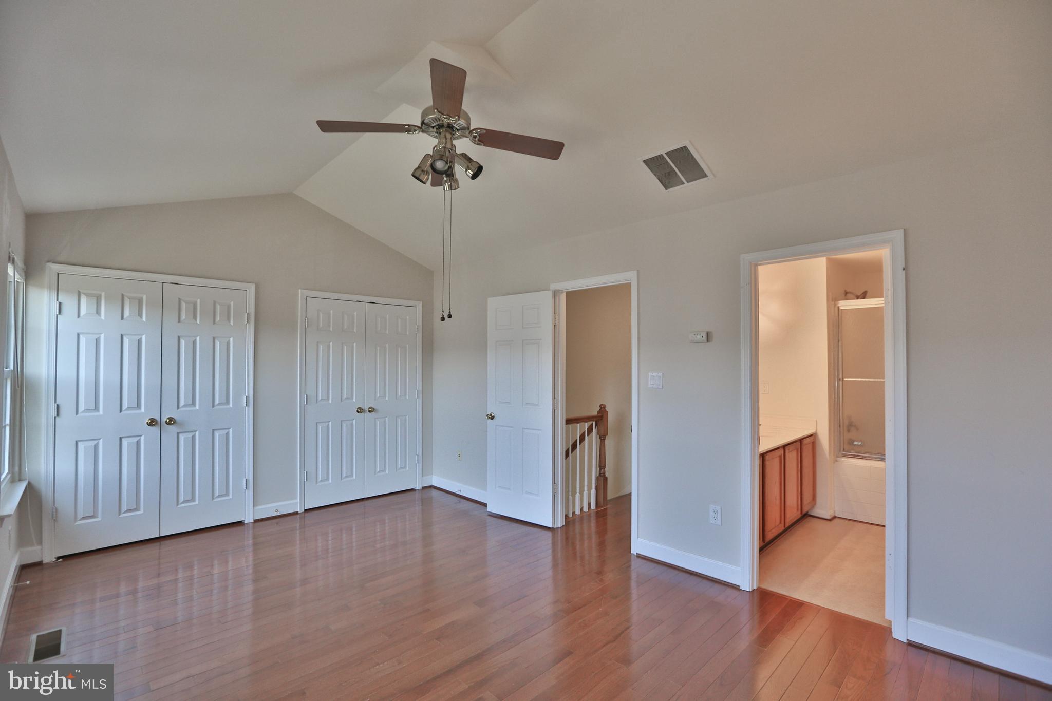 14214 Beddingfield Way Centreville, VA 20121 - Photo 14 of 19 a view of a room with wooden floor and ceiling fan