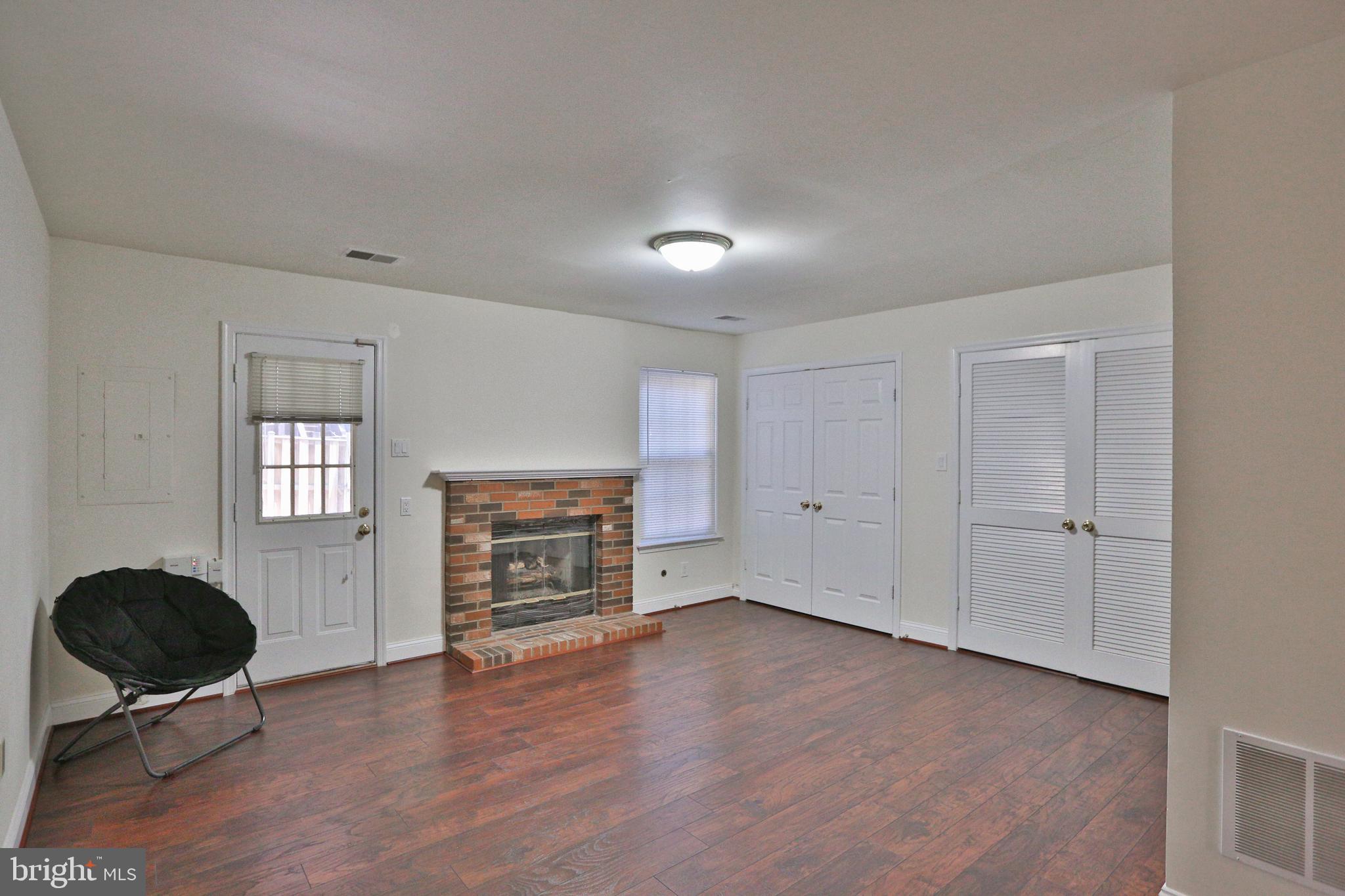 14214 Beddingfield Way Centreville, VA 20121 - Photo 4 of 19 an empty room with a fireplace and windows