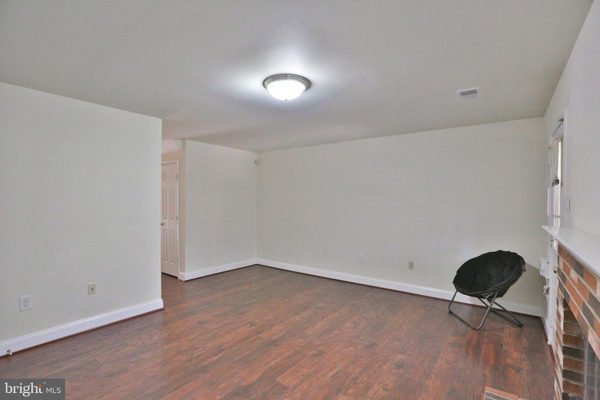 14214 Beddingfield Way Centreville, VA 20121 - Photo 5 of 19 wooden floor in an empty room with a window