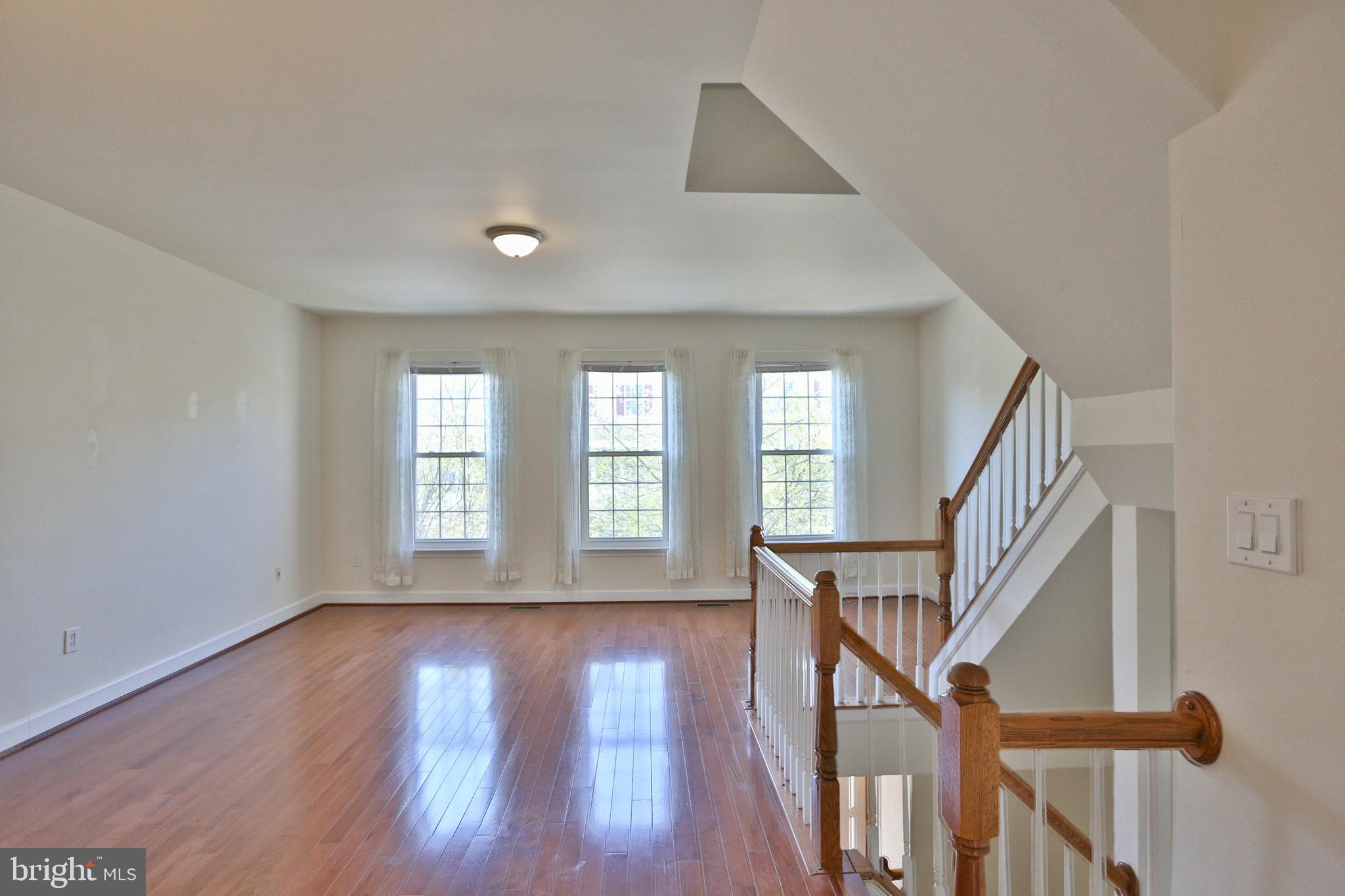 14214 Beddingfield Way Centreville, VA 20121 - Photo 8 of 19 a view of an entryway with wooden floor and stairs