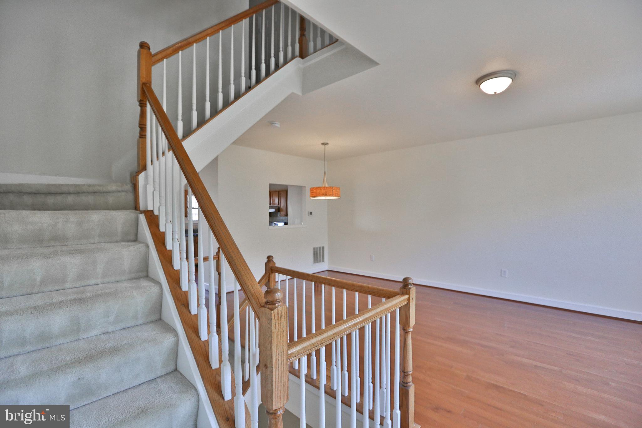 14214 Beddingfield Way Centreville, VA 20121 - Photo 9 of 19 a view of staircase with railing and white walls
