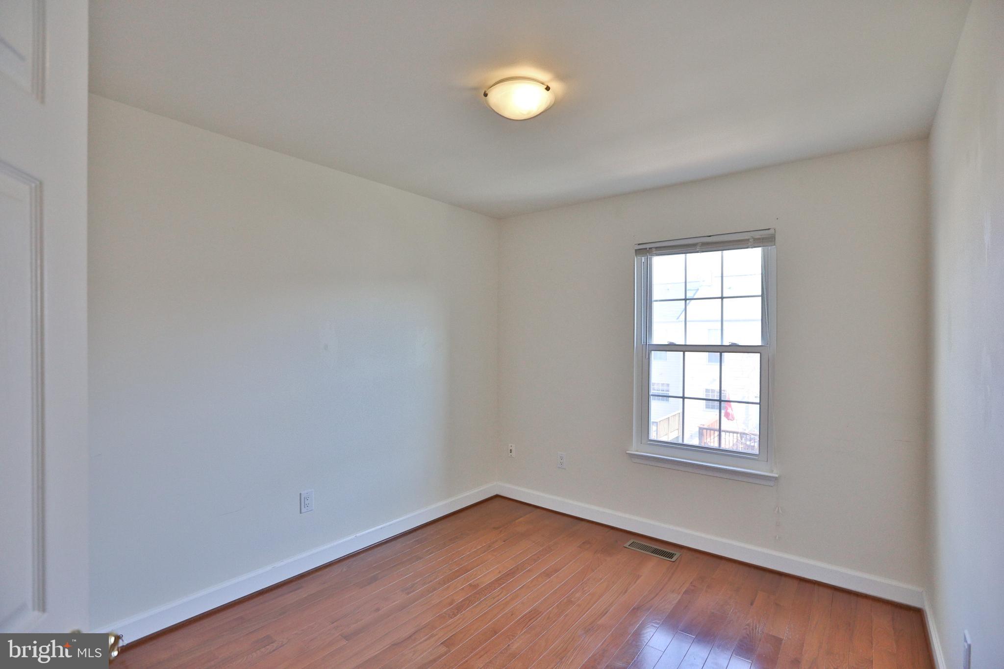 14214 Beddingfield Way Centreville, VA 20121 - Photo 10 of 19 an empty room with wooden floor and windows