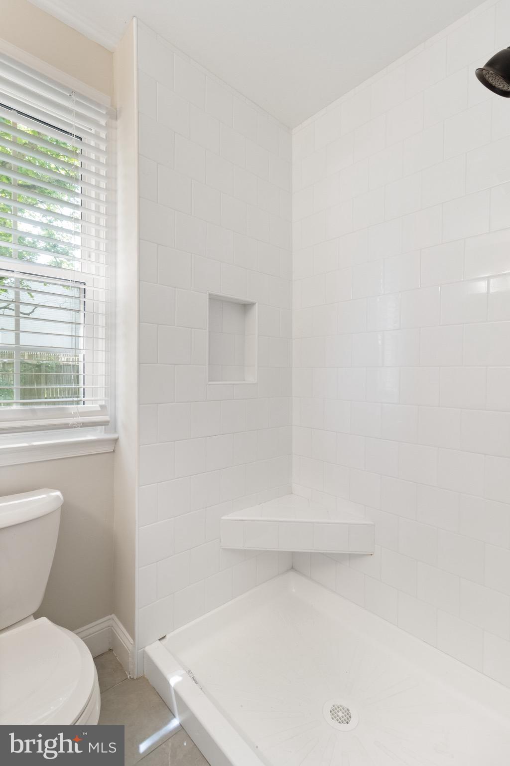 8581 Chester Grove Court Springfield, VA 22153 - Photo 24 of 38 a bathroom with a toilet and a window