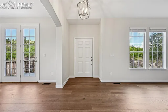 a view of a livingroom with wooden floor and a window