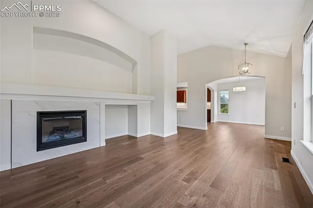 a view of a room with wooden floor and fireplace
