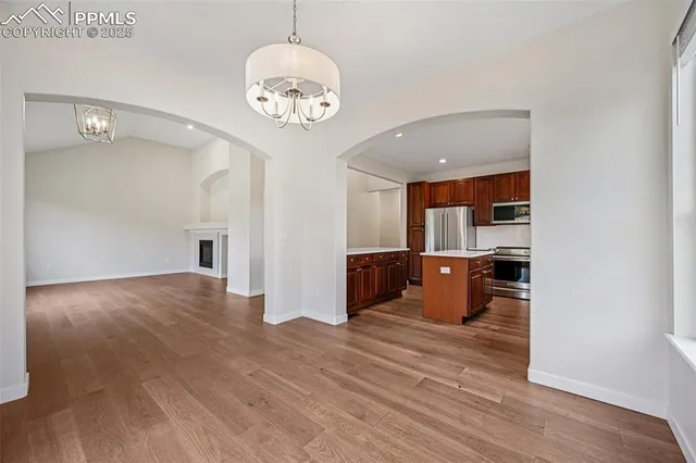 a view of a room with wooden floor