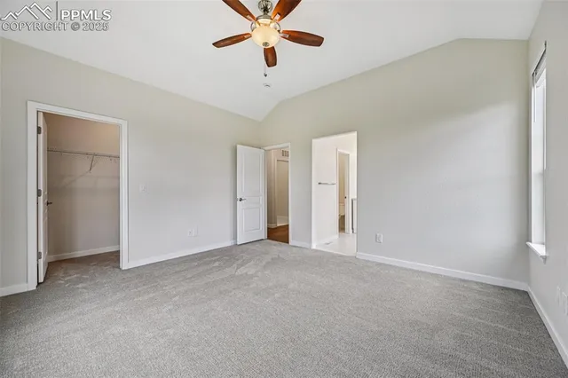 a view of an empty room with a ceiling fan