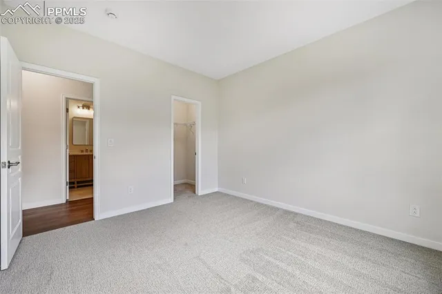 a view of an empty room and closet area