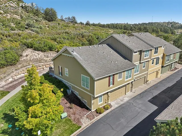 an aerial view of a house with a big yard