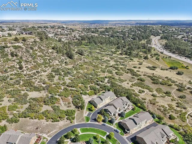 an aerial view of a house with a yard
