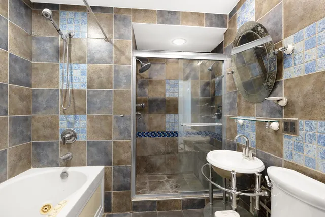 a bathroom with a sink mirror toilet and bathtub