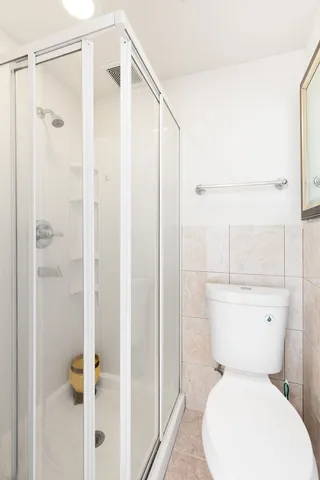 a white toilet sitting next to a bathroom sink