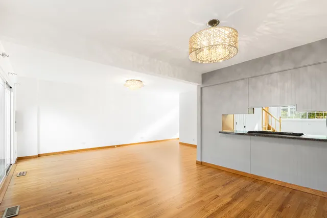 a view of kitchen and hall with wooden floor