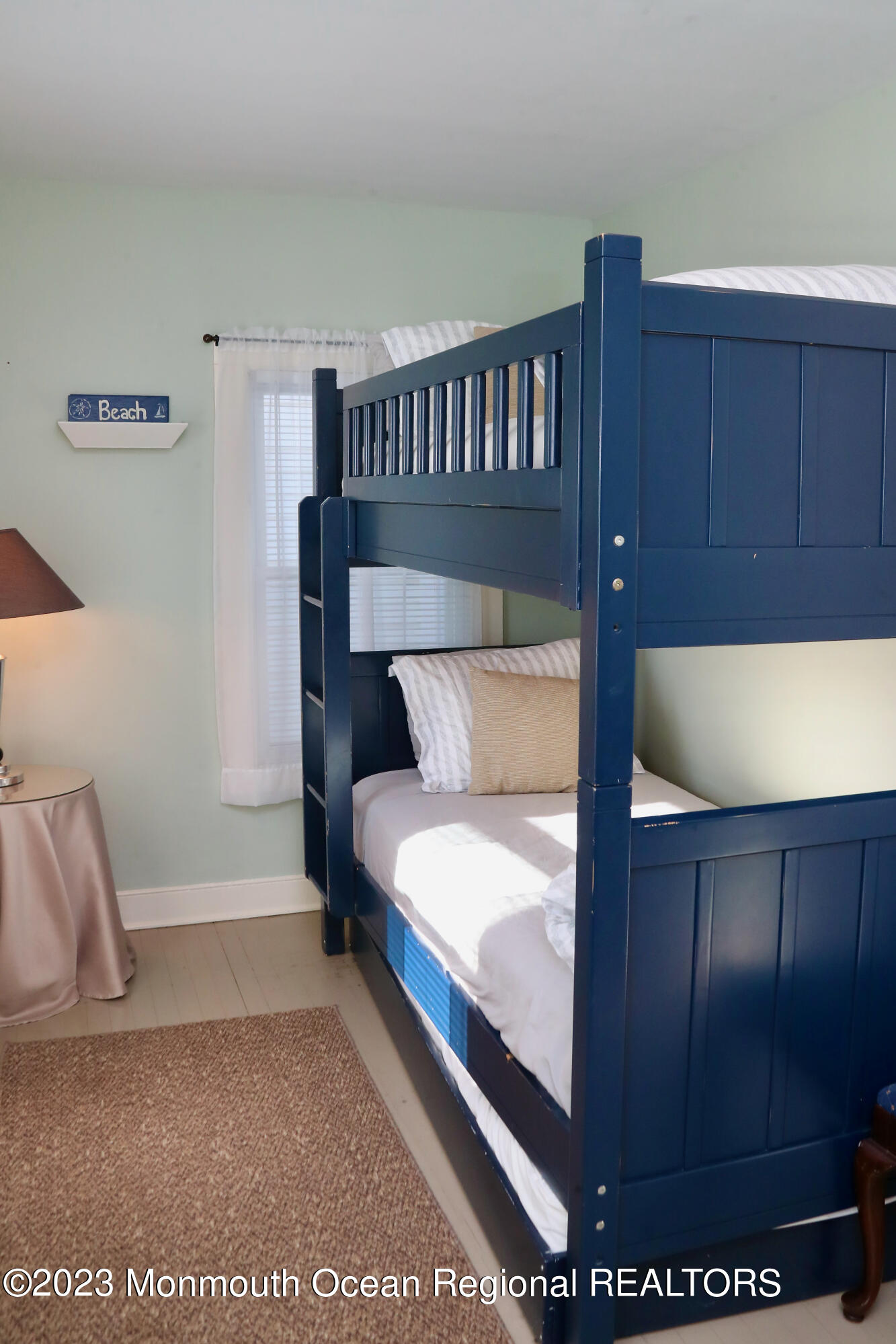 38 Ocean Pathway Ocean Grove, NJ 07756 - Photo 21 of 32 a bed sitting in a bedroom next to a wooden cabinet