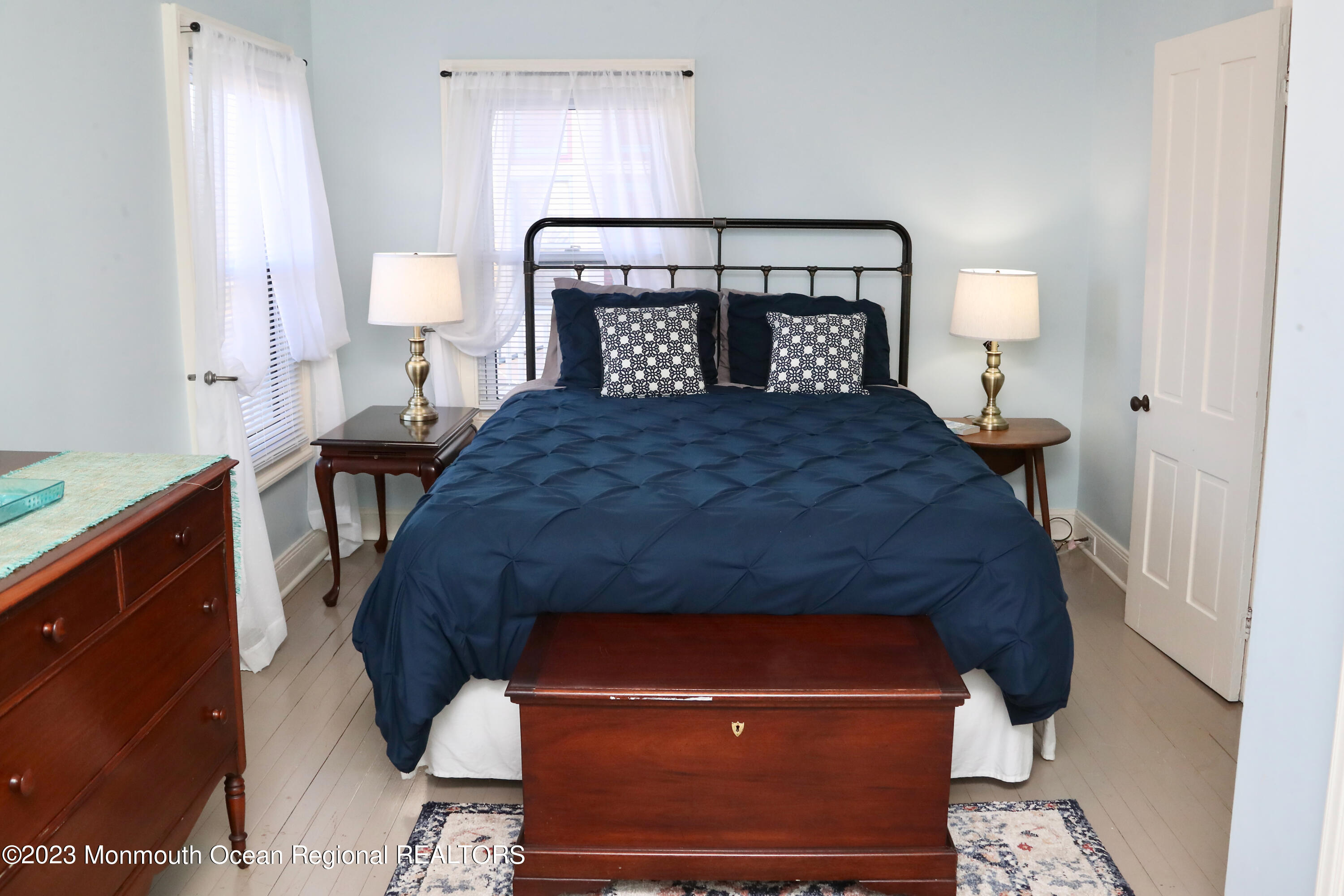 38 Ocean Pathway Ocean Grove, NJ 07756 - Photo 23 of 32 a bedroom with a bed and a lamp on table