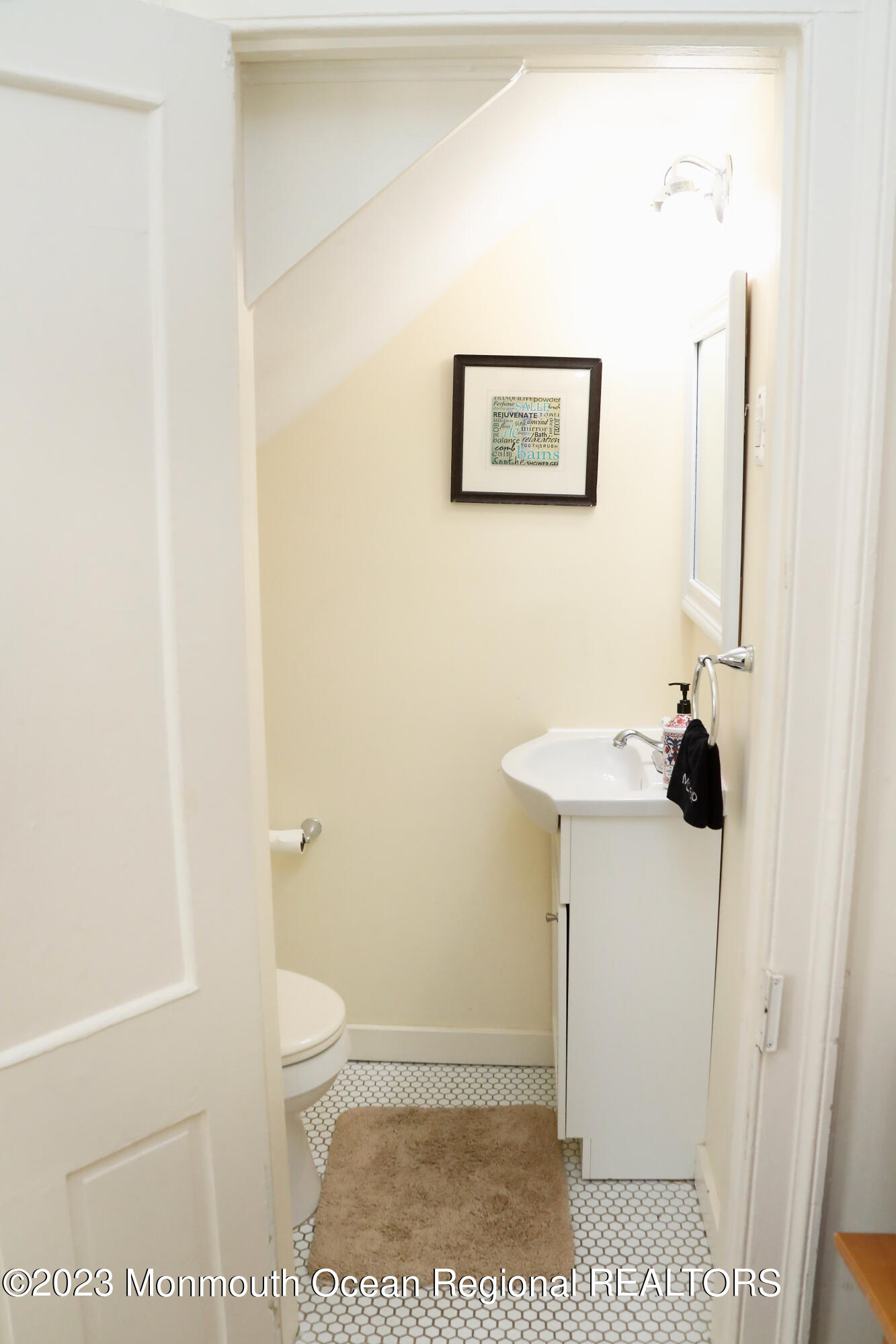38 Ocean Pathway Ocean Grove, NJ 07756 - Photo 25 of 32 a bathroom with a sink a toilet and a mirror