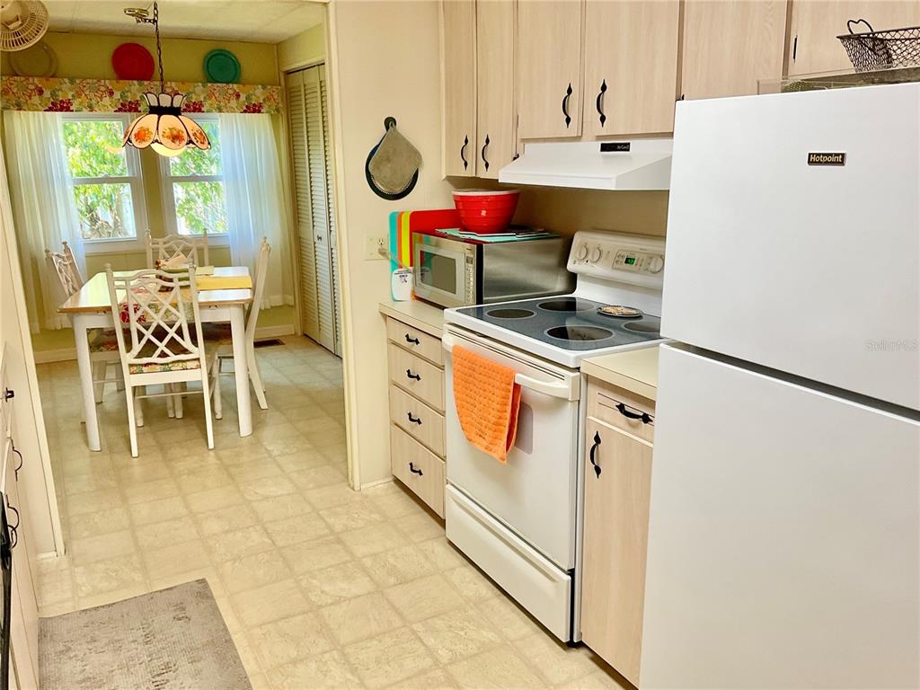 1100 South Belcher Road, Unit 100 Largo, FL 33771 - Photo 12 of 56 a kitchen with a sink a stove and a refrigerator