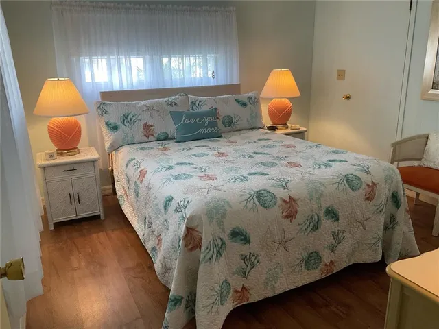 a bedroom with a bed and a painting on the wall