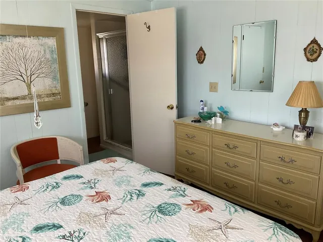 a bedroom with two beds and a dresser