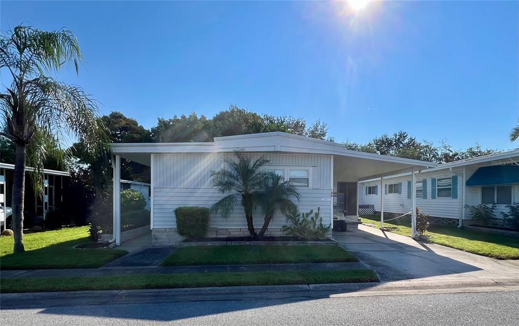 1100 South Belcher Road, Unit 100 Largo, FL 33771 - Photo 2 of 56 a front view of a house with garden