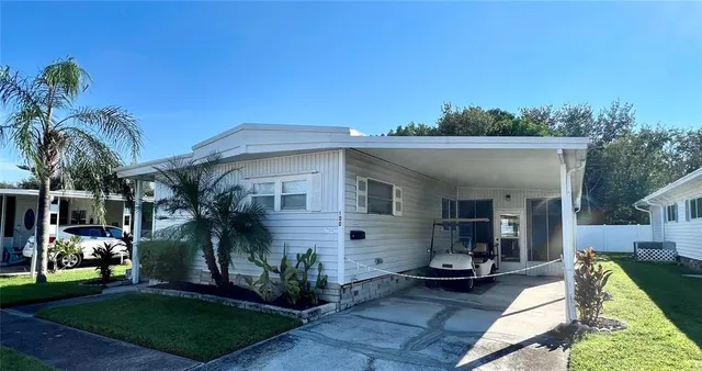 a front view of house with yard outdoor seating and green space