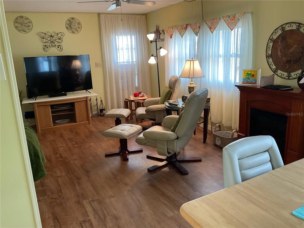 1100 South Belcher Road, Unit 100 Largo, FL 33771 - Photo 8 of 56 a living room with furniture and a flat screen tv