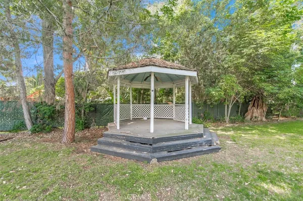 a view of a house with backyard and sitting area