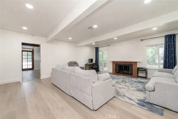a living room with furniture a fireplace and a table