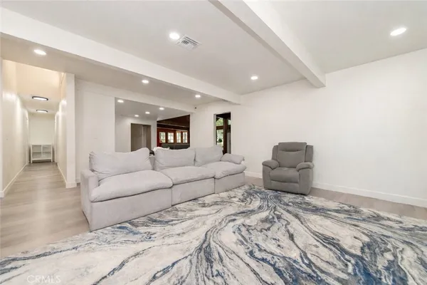 a large bedroom with a bed and a couch