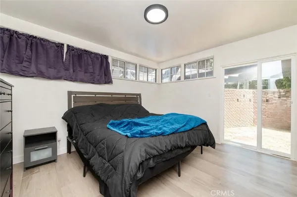 a bedroom with a bed and a flat tv screen