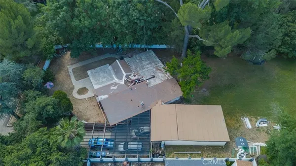an aerial view of a house with outdoor space pool seating area and yard