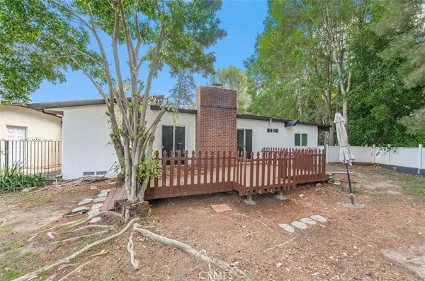 a view of a house with a yard and tree s