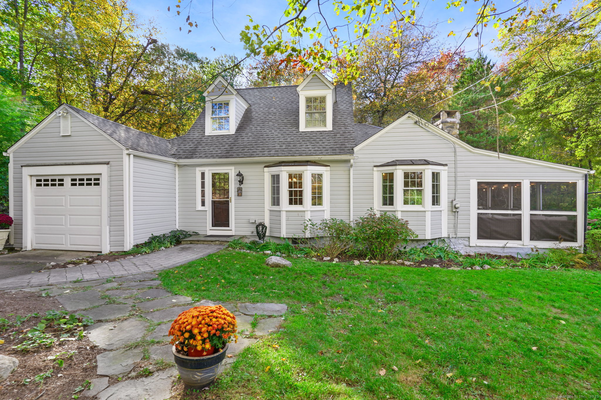 a front view of a house with a garden and yard