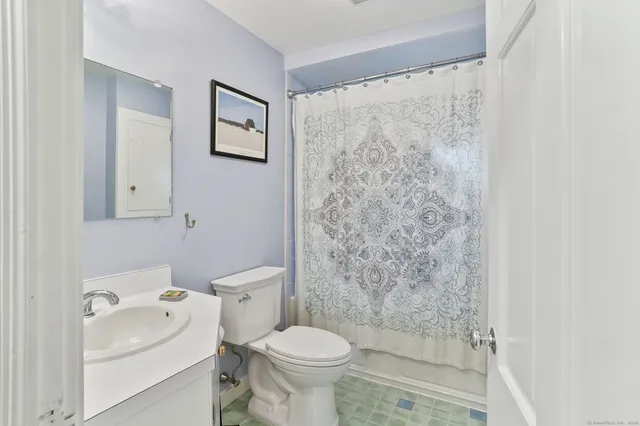 a white toilet sitting next to a bathroom sink