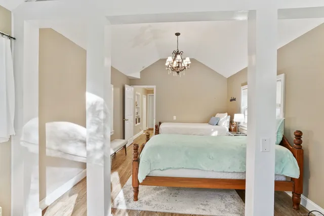 a bedroom with a bed and chandelier