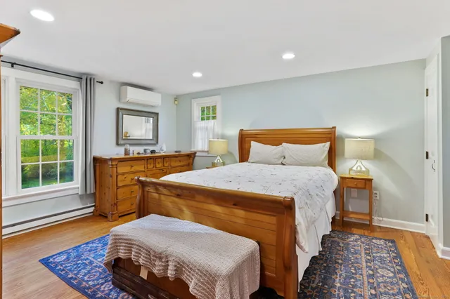 a bedroom with a bed and window