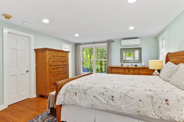 a bedroom with a large bed and a window