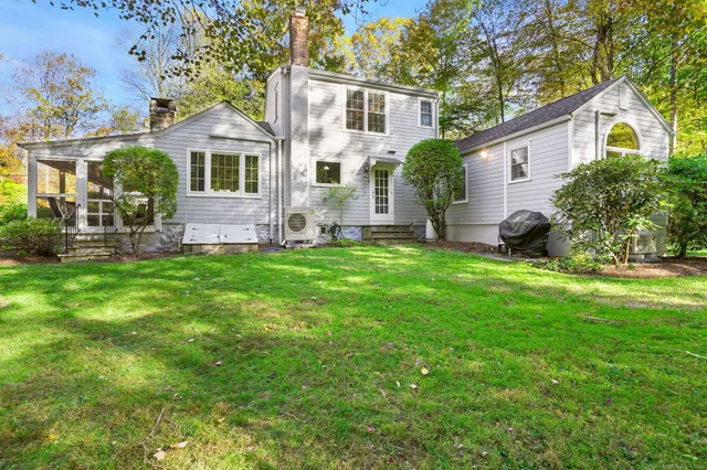 a view of a house with a yard and sitting area