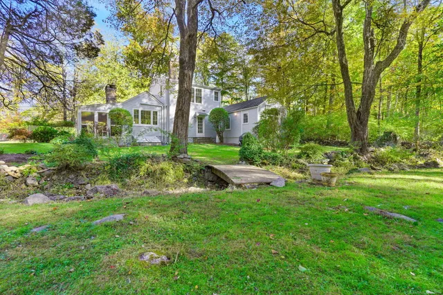 a view of a house with a backyard