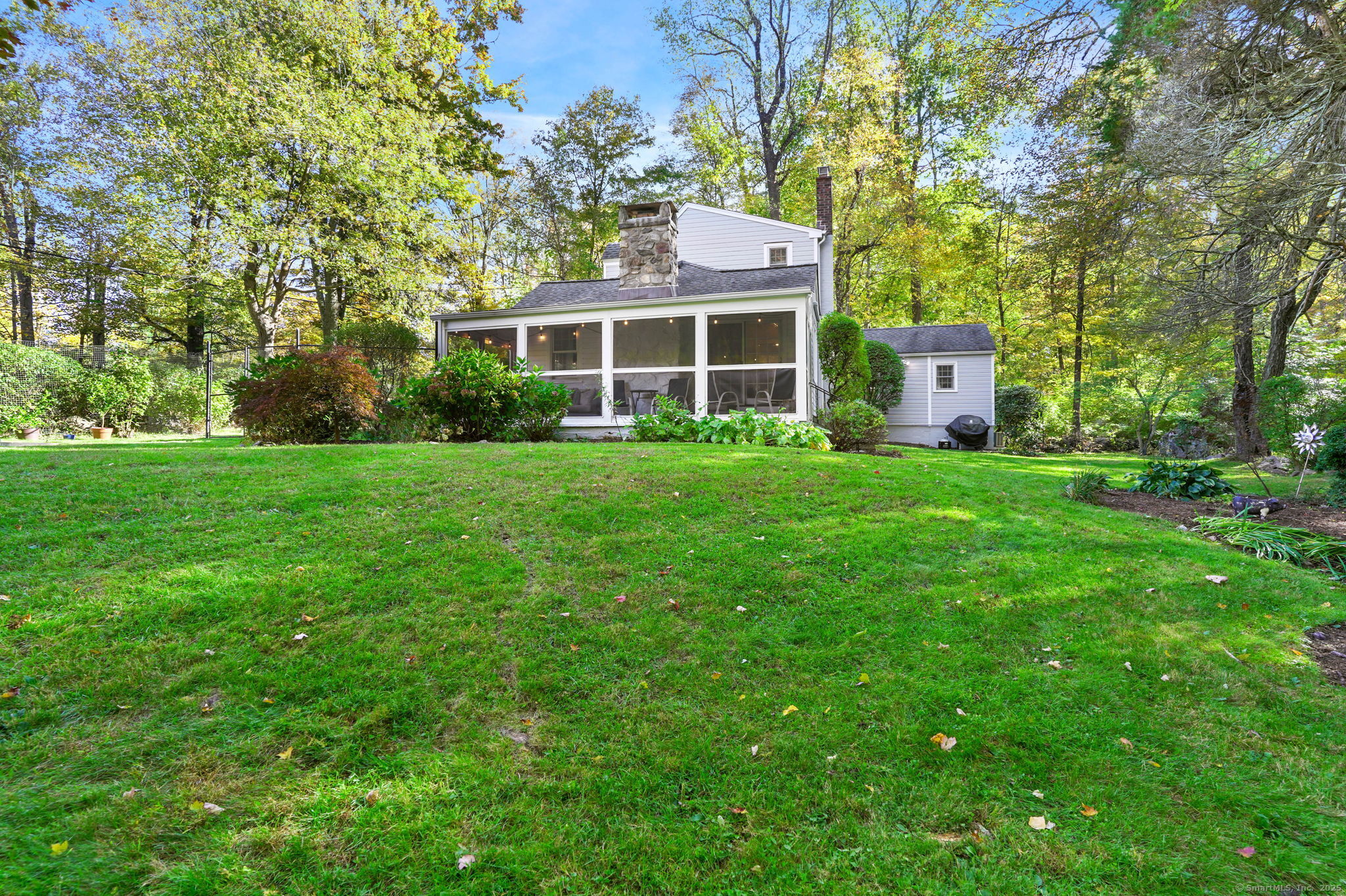 477 Newtown Turnpike Redding, CT 06896 - Photo 29 of 38 a front view of a house with a garden
